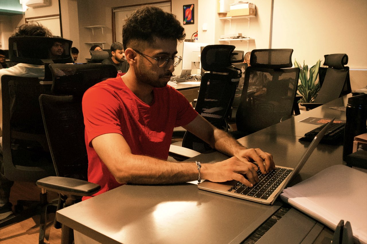 a builder heads-down on his agent at the long desk