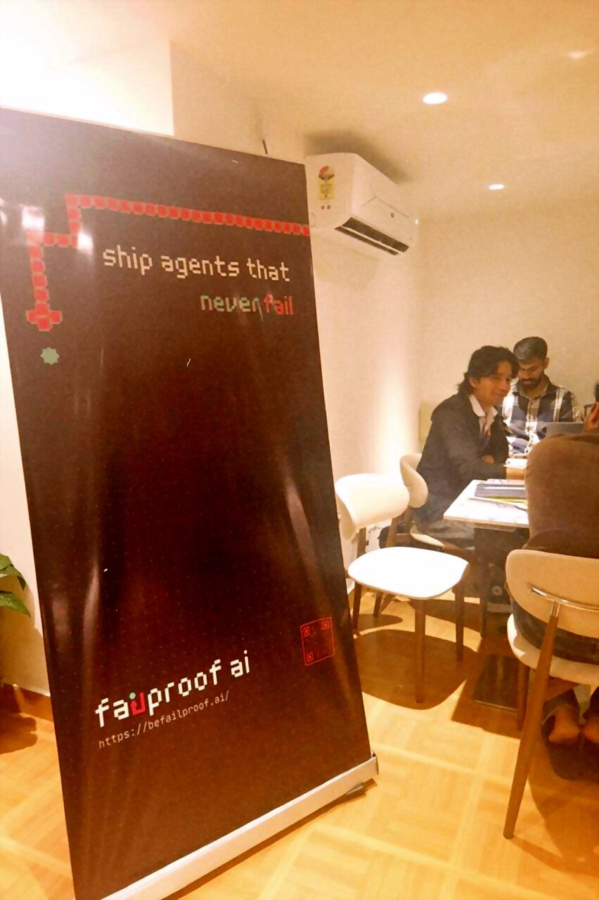 the failproof ai banner, "ship agents that never fail", inside the cafe