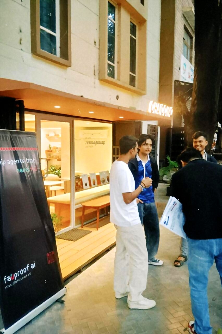 attendees talking at the cafe entrance next to the failproof ai banner